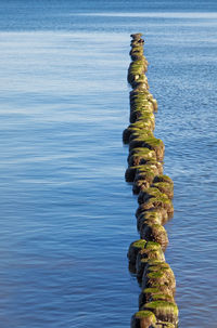 Stack of rocks on wooden post at beach