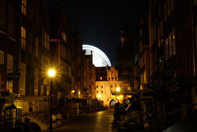 Illuminated city against sky at night