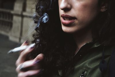 Close-up of young woman smoking