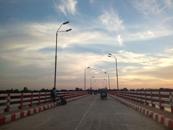 Street lights against sky during sunset