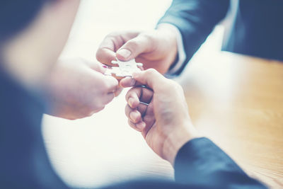 Midsection of couple holding hands