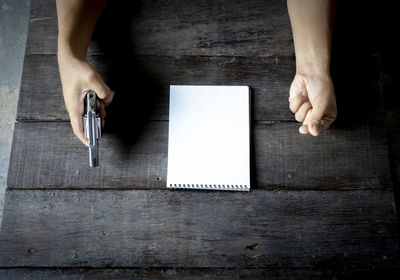 Directly above shot of woman hand on table