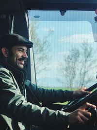 Smiling man driving car