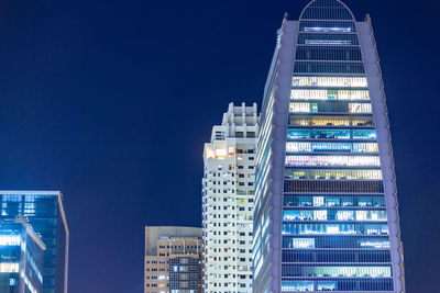 Low angle view of modern buildings against clear blue sky