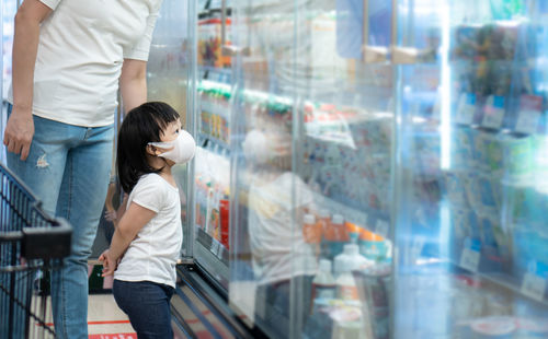 Side view of women standing at store