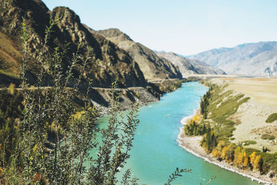 View of the turquoise river katun and altai mountains, autumn season