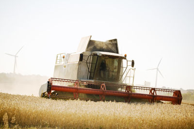 Combine harvester on wheat field