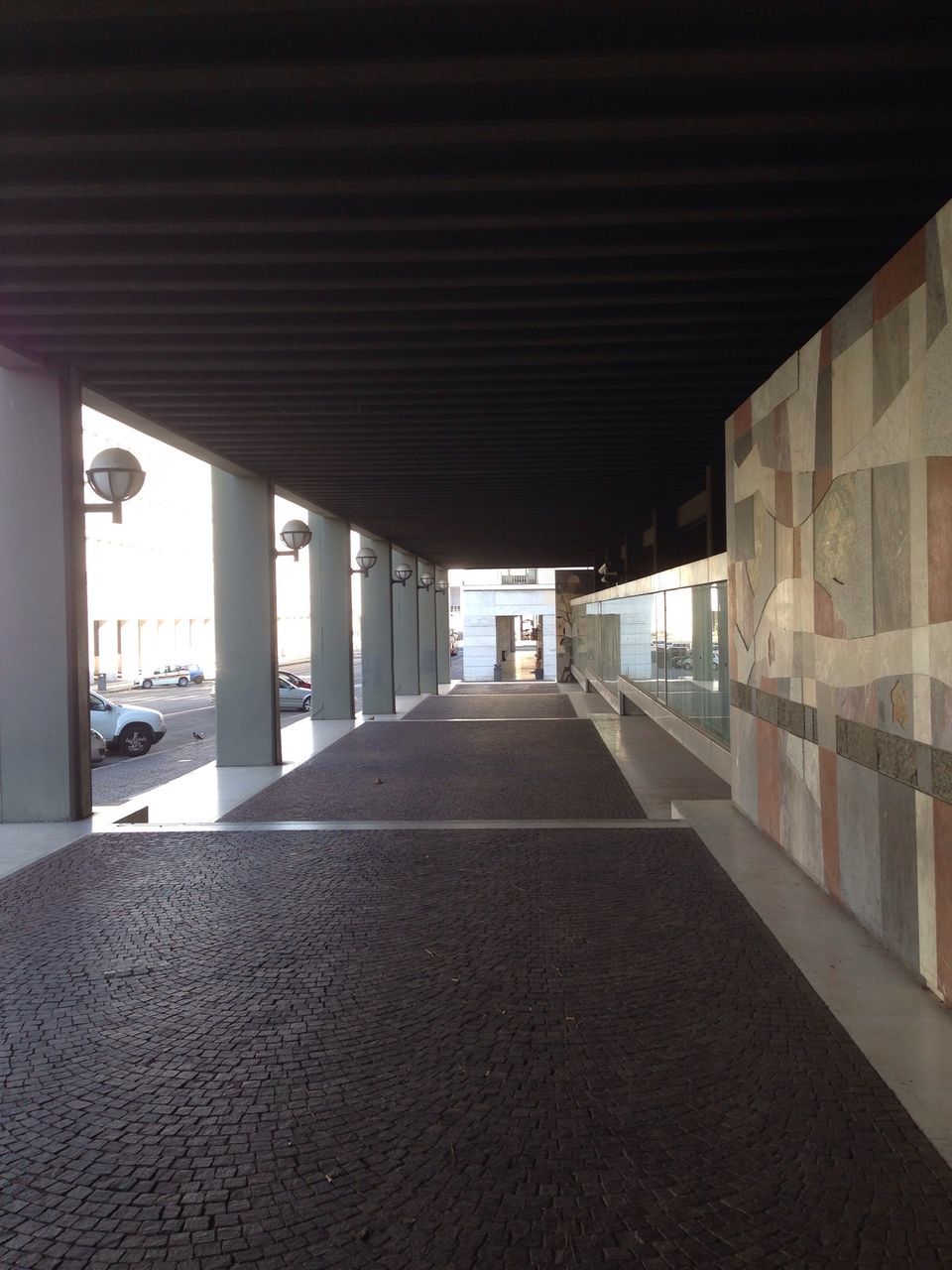 indoors, the way forward, architecture, built structure, diminishing perspective, corridor, ceiling, architectural column, empty, vanishing point, in a row, long, column, flooring, absence, transportation, colonnade, sunlight, walkway, no people