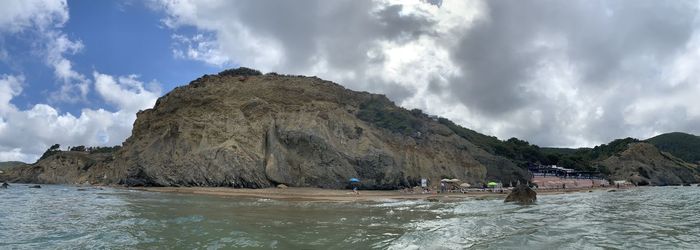 Scenic view of sea and mountains against sky