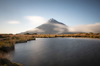 Scenic view of lake against cloudy sky