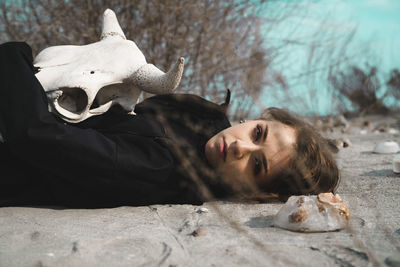 Portrait of woman lying down on land