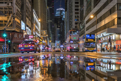 View of city street and buildings at night