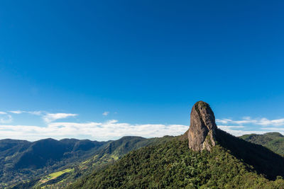 Scenic view of mountains against blue sky