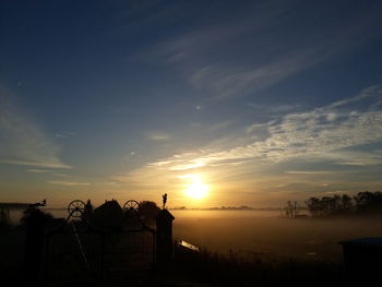 Scenic view of silhouette land against sky during sunset