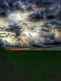 Scenic view of landscape against cloudy sky