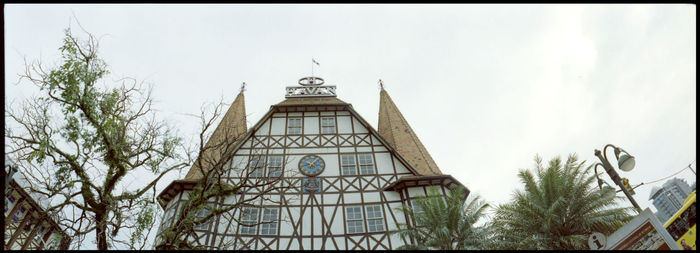 Low angle view of clock tower against sky