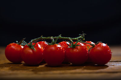 Close-up of tomatoes on table against black background