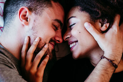 Portrait of young couple kissing