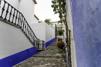 Footpath amidst buildings in city