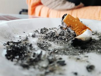 Close-up of cigarette in ashtray