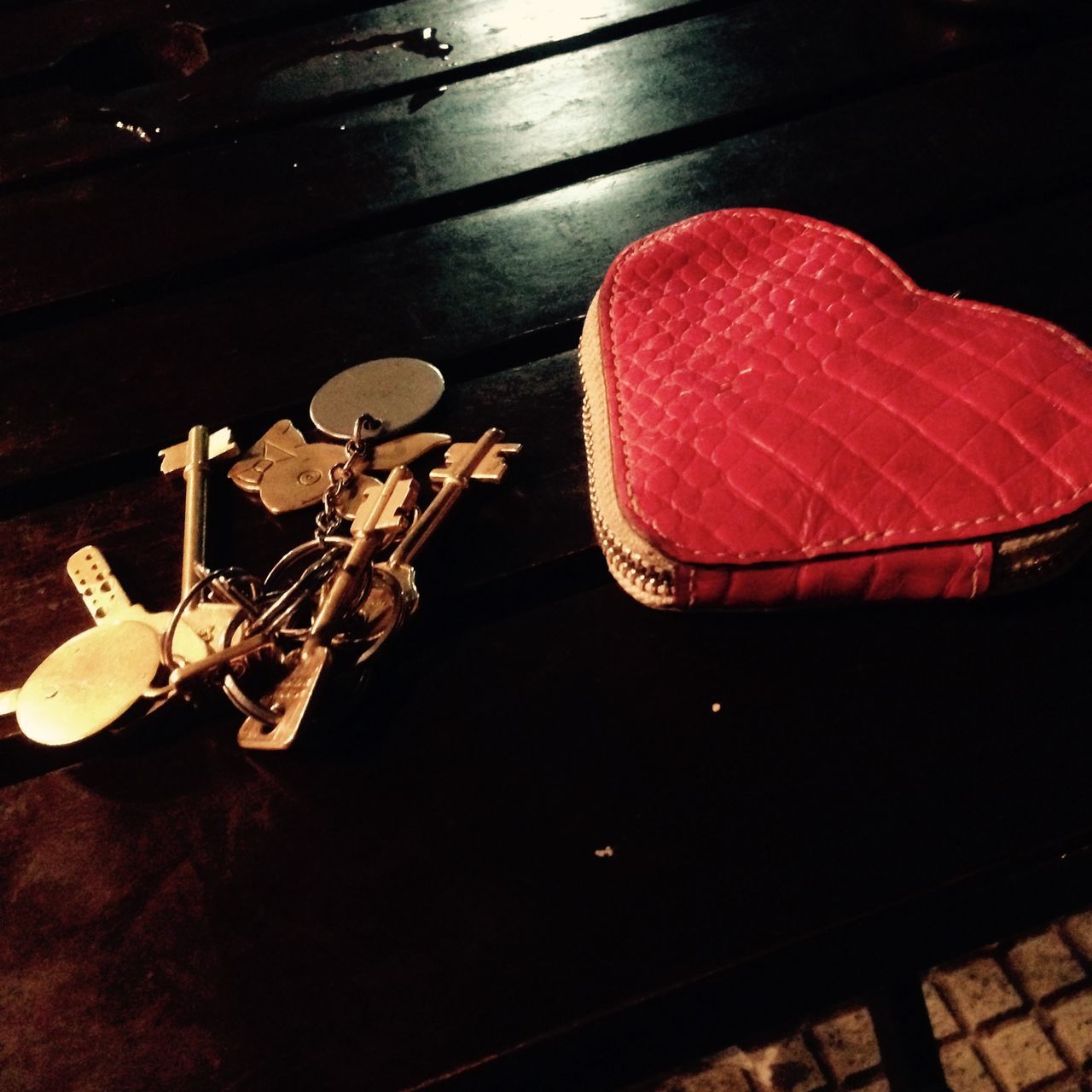 indoors, high angle view, night, still life, red, table, arts culture and entertainment, illuminated, chair, wood - material, no people, close-up, absence, seat, dark, shadow, shoe, flooring, musical instrument, directly above