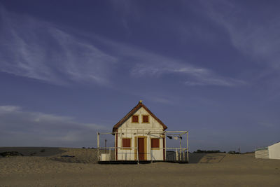 House on beach against sky