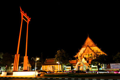 Illuminated temple building against sky at night