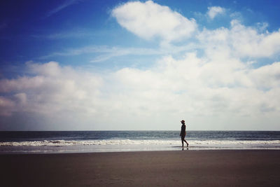 Full length of man on beach against sky