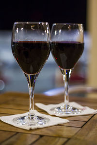 Two glasses of red wine on wooden table