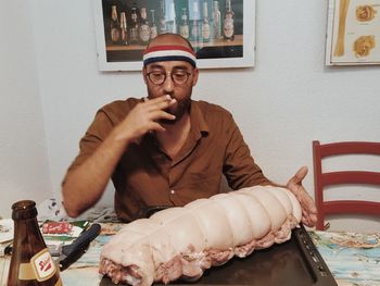 Close-up of man sitting on table