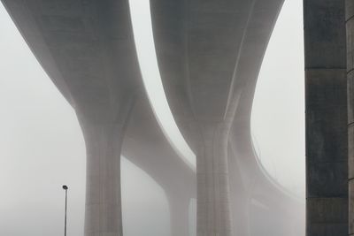 Low angle view of bridge in foggy weather