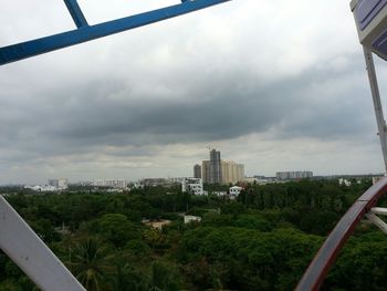 Buildings against cloudy sky