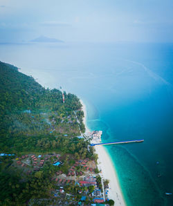 High angle view of townscape by sea against sky