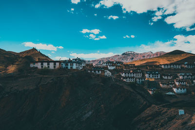 Houses on mountain against blue sky