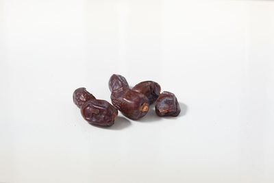 Close-up of coffee beans against white background