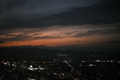 High angle view of illuminated buildings against sky at night