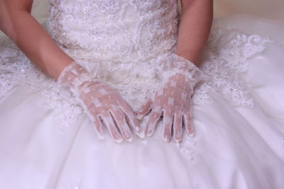 Midsection of bride wearing wedding dress