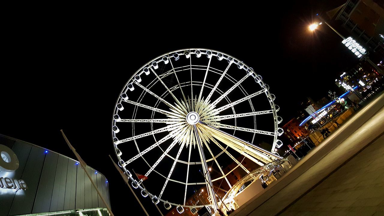 LOW ANGLE VIEW OF ILLUMINATED FERRIS WHEEL