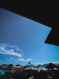 Low angle view of buildings against blue sky