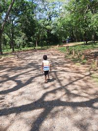 Rear view of boy walking in park