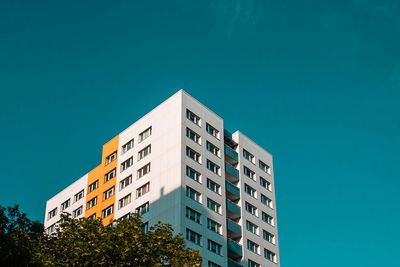 Low angle view of building against clear blue sky