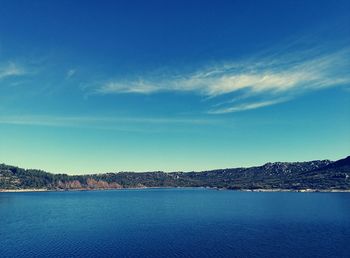 Scenic view of sea against blue sky