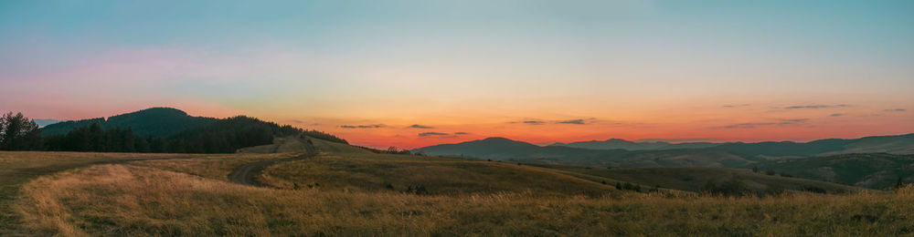 Scenic view of field against sky during sunset