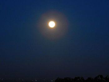 Low angle view of moon against clear blue sky