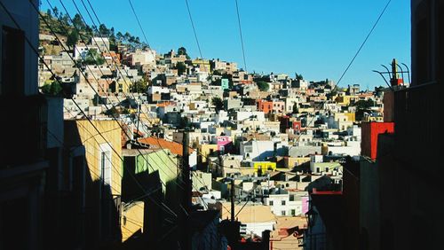 View of buildings against clear blue sky