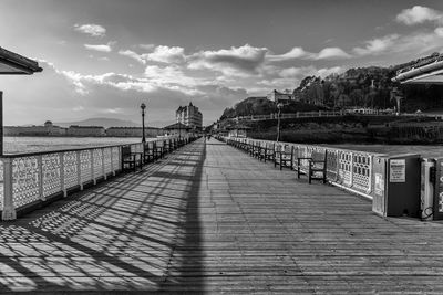 View of bridge over sea against cloudy sky