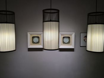 Close-up of electric lamp hanging on wall at home