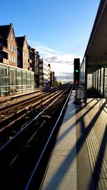 Train at railroad station against sky