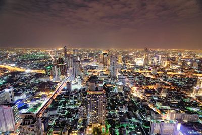 High angle view of illuminated buildings in city at night