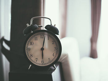 Close-up of clock on wall at home